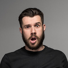 Image showing Portrait of a young puzzled businessman with opened mouth