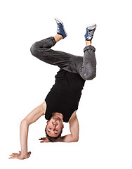 Image showing Break dancer doing one handed handstand against a white background