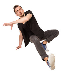 Image showing Break dancer doing one handed handstand against a white background