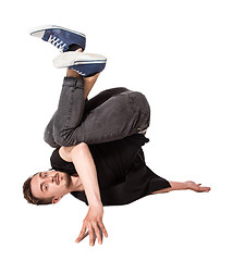 Image showing Break dancer doing one handed handstand against a white background