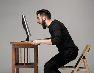 Image showing Funny and crazy man using a computer