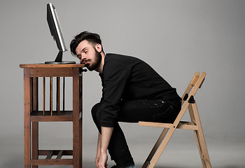 Image showing Businessman sleeping on a computer