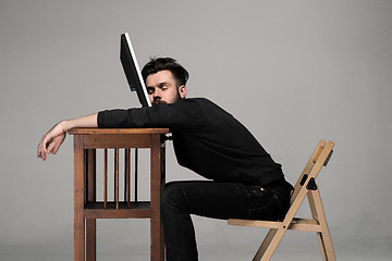 Image showing Businessman sleeping on a computer