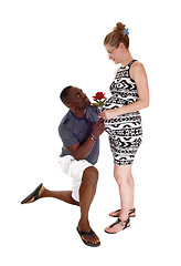 Image showing Black man kneeling for white pregnant woman.