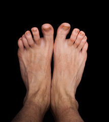 Image showing Pair of caucasian male feet isolated towards black