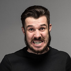 Image showing Portrait of young fierce man in studio