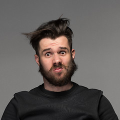 Image showing Portrait of young tousled man in studio