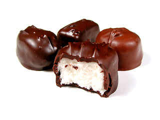 Image showing Chocolates on white, one bitten