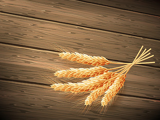 Image showing Wheat on wooden background. EPS 10 