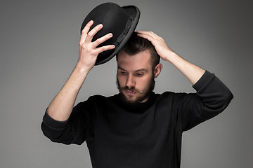 Image showing Young man raising his hat  in respect and admiration for someone 