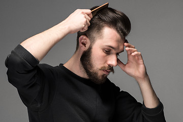 Image showing young man comb his hair