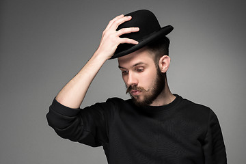 Image showing Young man raising his hat  in respect and admiration for someone 