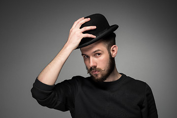 Image showing Young man raising his hat  in respect and admiration for someone 