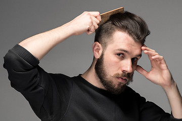 Image showing young man comb his hair