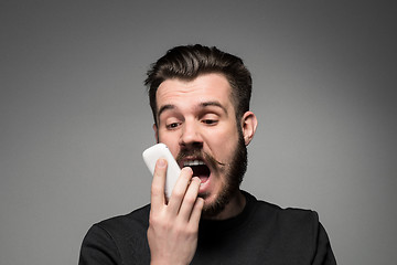 Image showing Portrait of screaming man talking on the phone