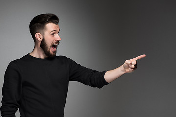 Image showing Excited man pointing a great idea - over gray background