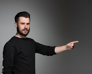 Image showing The man pointing a great idea - over gray background