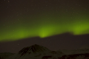 Image showing Northern lights with snowy mountains in the foreground