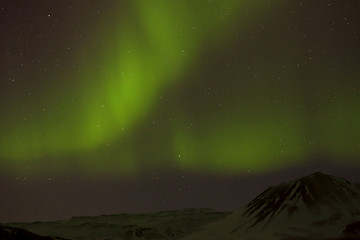 Image showing Northern lights with snowy mountains in the foreground