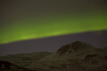 Image showing Northern lights with snowy mountains in the foreground