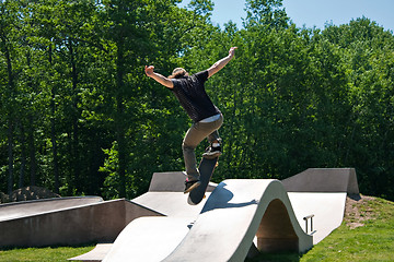 Image showing Skateboarder Jumping Skate Ramp