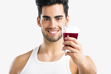 Image showing Athletic man drinking a juice