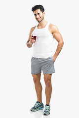 Image showing Athletic man drinking a juice