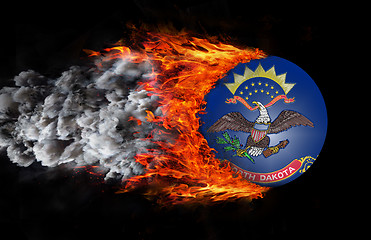 Image showing Flag with a trail of fire and smoke - North Dakota