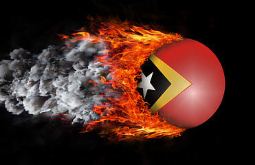 Image showing Flag with a trail of fire and smoke - East Timor