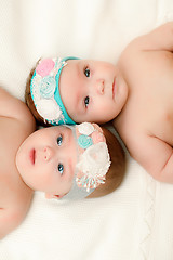 Image showing Two twin babies, girls in nice headbands