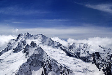 Image showing Snowy mountains in clouds