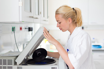 Image showing Attractive young scientist pipetting.