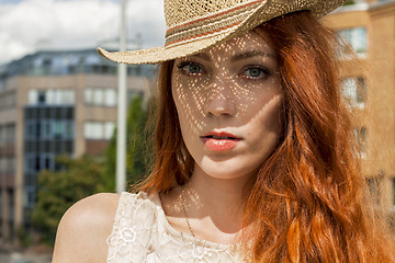 Image showing Gorgeous Woman in Hat on Cloudy Sky background