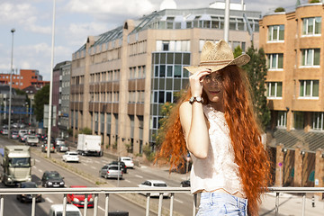 Image showing Gorgeous Woman in Hat on Cloudy Sky background