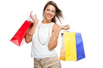 Image showing Happy Woman Raising Colored Shopping Bag