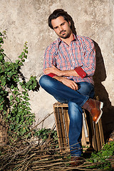 Image showing Male model sitting with legs crossed