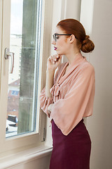 Image showing Office Woman Looking Outside Through Glass Window