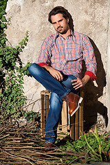 Image showing Male model sitting with legs crossed