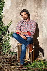 Image showing Male model sitting with legs crossed