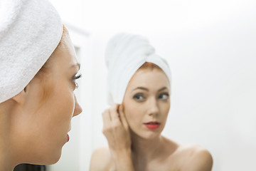 Image showing Woman From Shower Looking her Face at the Mirror