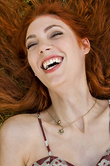 Image showing Happy Woman Lying on Grassy Ground