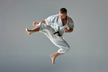 Image showing Man in white kimono training karate