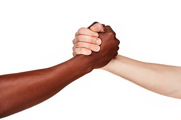 Image showing Black and white human hands in a modern handshake 