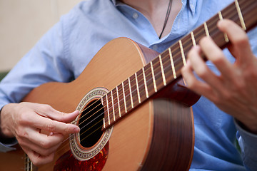 Image showing Man playing classic, acoustic guitar