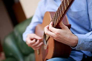 Image showing Man playing classic, acoustic guitar