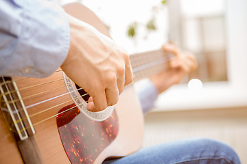 Image showing Man playing classic, acoustic guitar