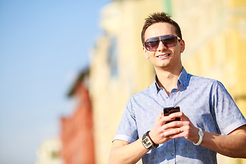 Image showing Outdoor portrait of man with mobile phone in the street.