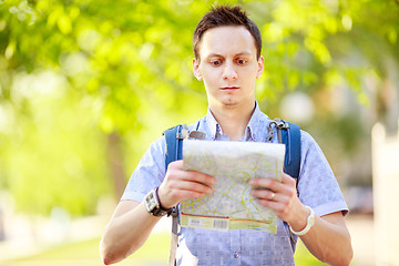 Image showing Young man with a map outdoors