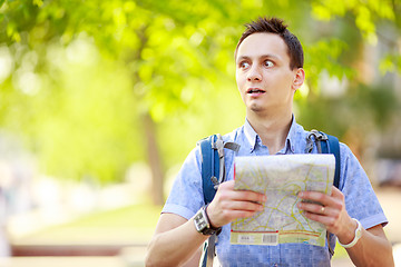 Image showing Young man with a map outdoors