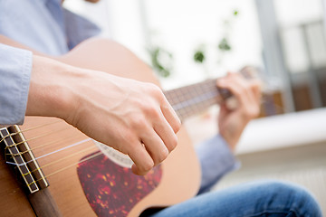 Image showing Man playing classic, acoustic guitar